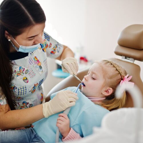 Little baby girl at dentist chair. Children dental.